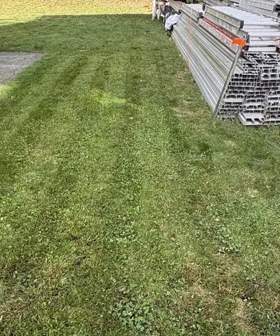 After: the same lawn cut short, with mowing stripes across it, next to the same staging. A label under the photo points to the stripes.